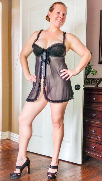 Sexy redhead Kelli in black lingerie posing and spreading pussy