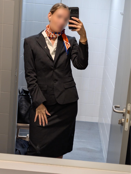 Flight attendant MILF taking a mirror selfie in her uniform