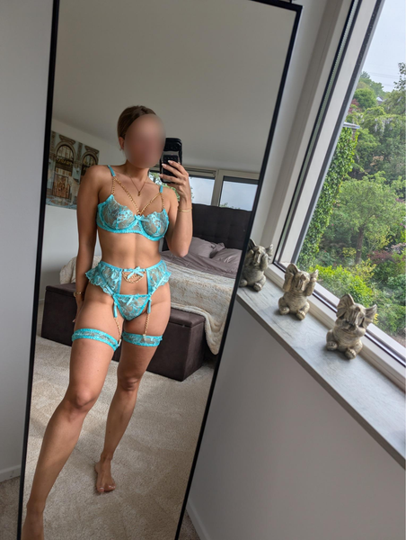 Flight attendant mom in teal lace lingerie with garters and gold chains