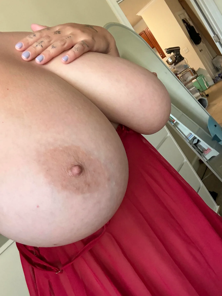 Close up of a topless MILF’s big natural breast and nipple