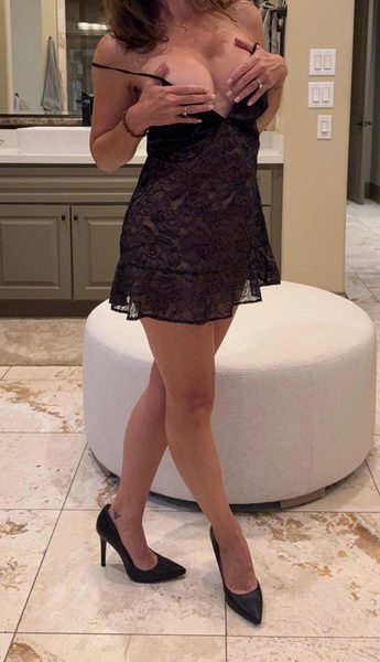 Real hotwife pulling her black lace slip down to show her breasts